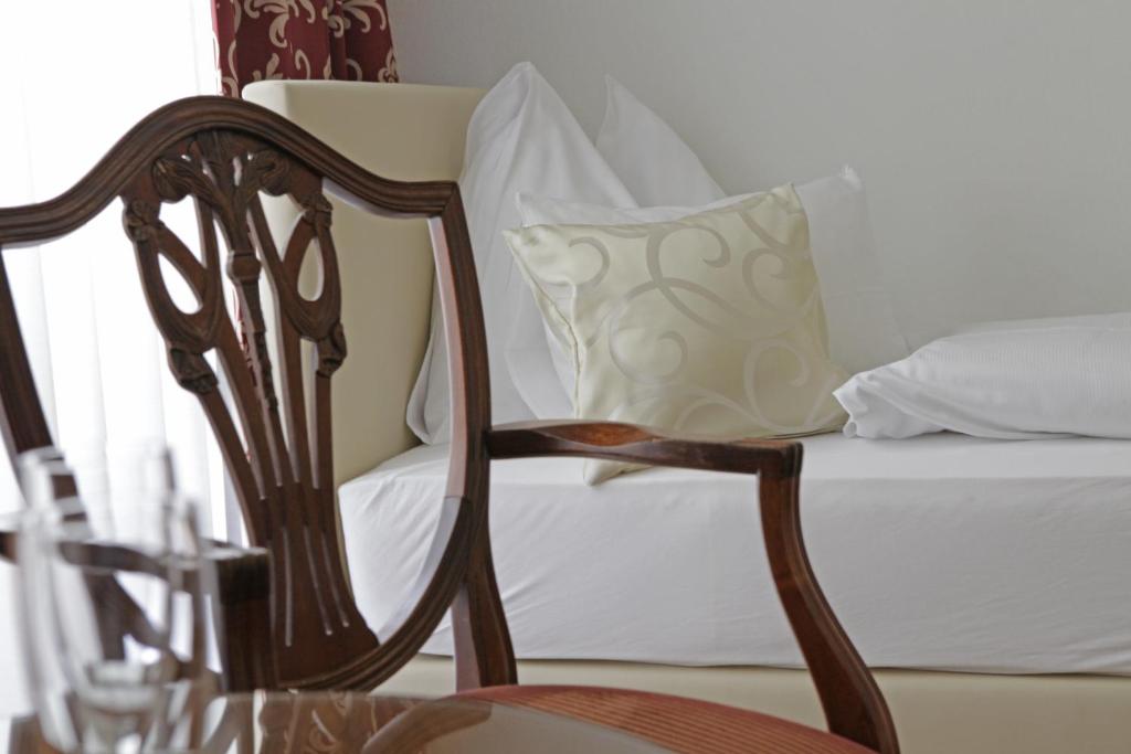 Uma cama ou camas num quarto em Hotel Domizil