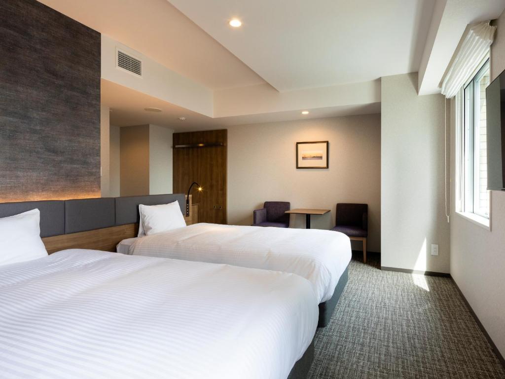 Postel nebo postele na pokoji v ubytování Hotel Rilassare Tokyo