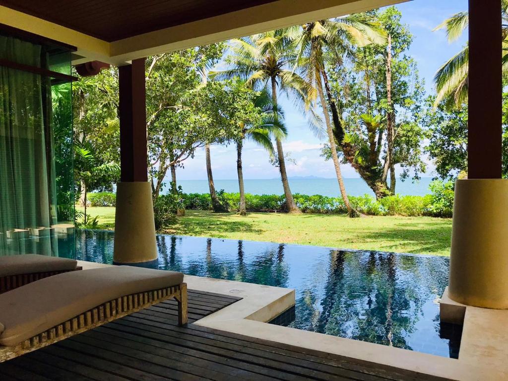 a view of the ocean from a house with a swimming pool at Amatapura Beachfront Villa 10 , SHA Certified in Ao Nam Mao