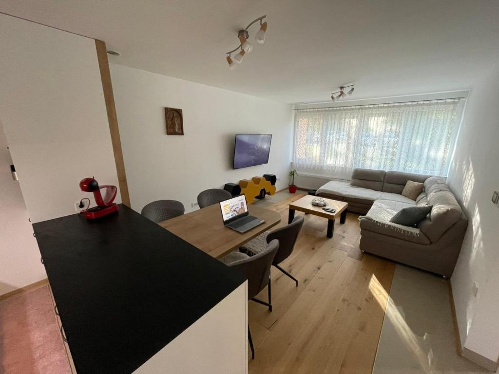 a living room with a couch and a table at Delux apartment ARSO in Velenje