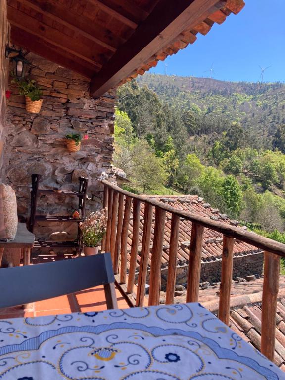 a balcony of a house with a table and chairs at Casa da Carolina in Lousã