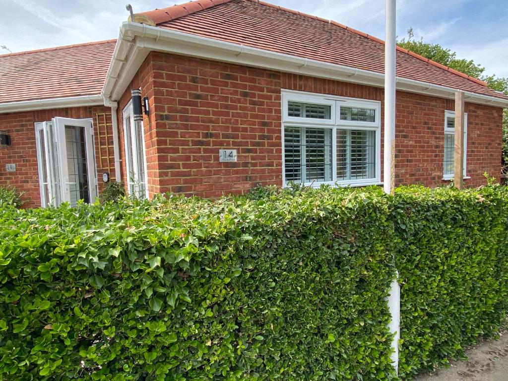 a brick house with a hedge in front of it at The Bolthole in Margate