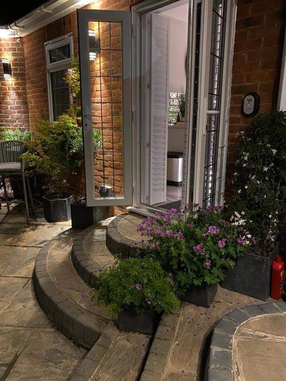 a porch with flowers and plants in front of a door at The Bolthole in Margate