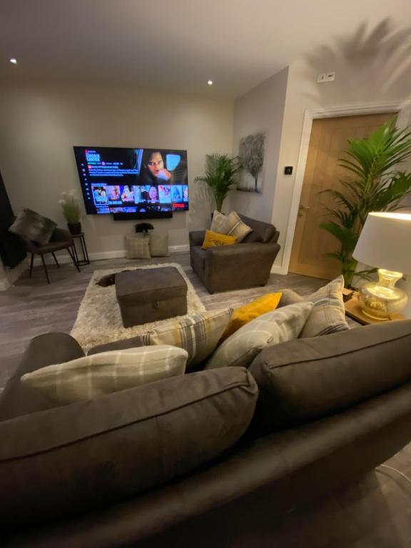 a living room with a couch and a flat screen tv at The Bolthole in Margate