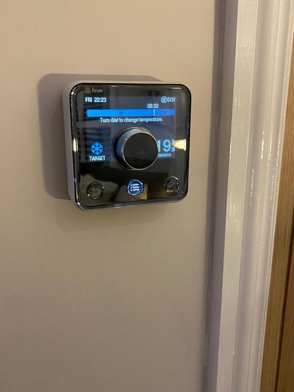 a cell phone is hanging on a wall at The Bolthole in Margate