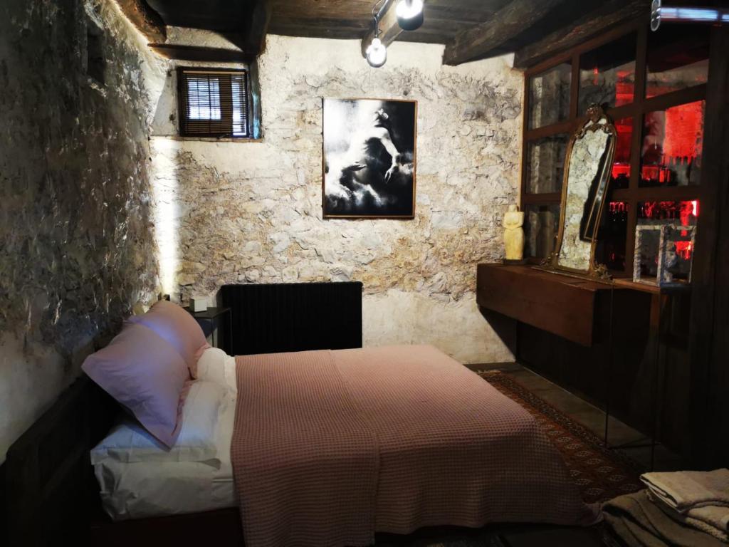 a bedroom with a bed in a stone wall at B&B con SPA il Castello di Lucawest in Ponteranica