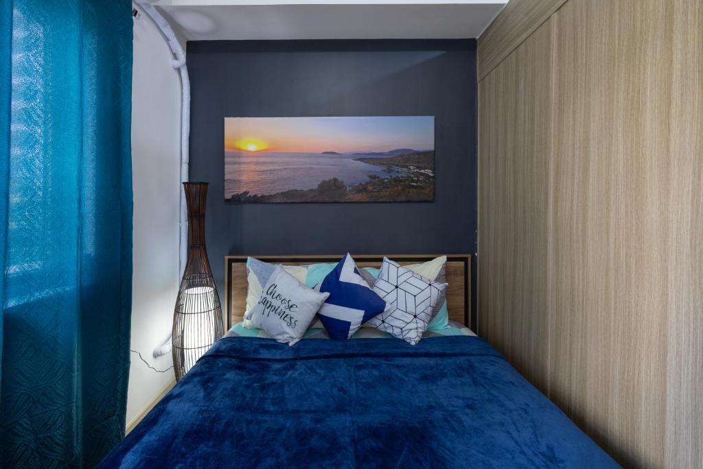 a bedroom with a bed with blue sheets and pillows at Bella Vita at Grace Residences in Manila
