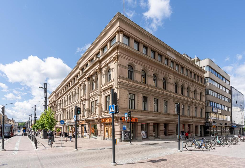 a large building on the corner of a city street at 2ndhomes Tampere "Penthouse" Apartment - Private Sauna & Terrace in Tampere