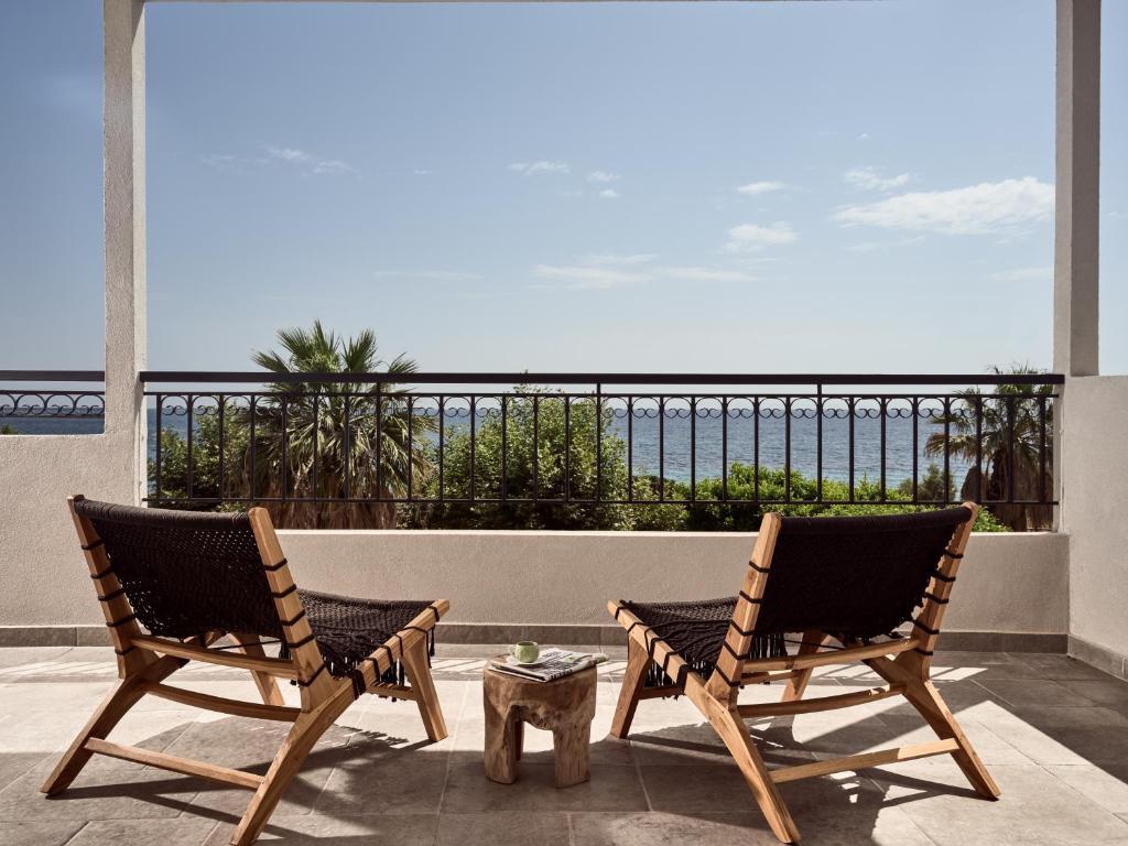 two chairs on a balcony with a view of the ocean at Margie Sea View Apartment in Zakynthos