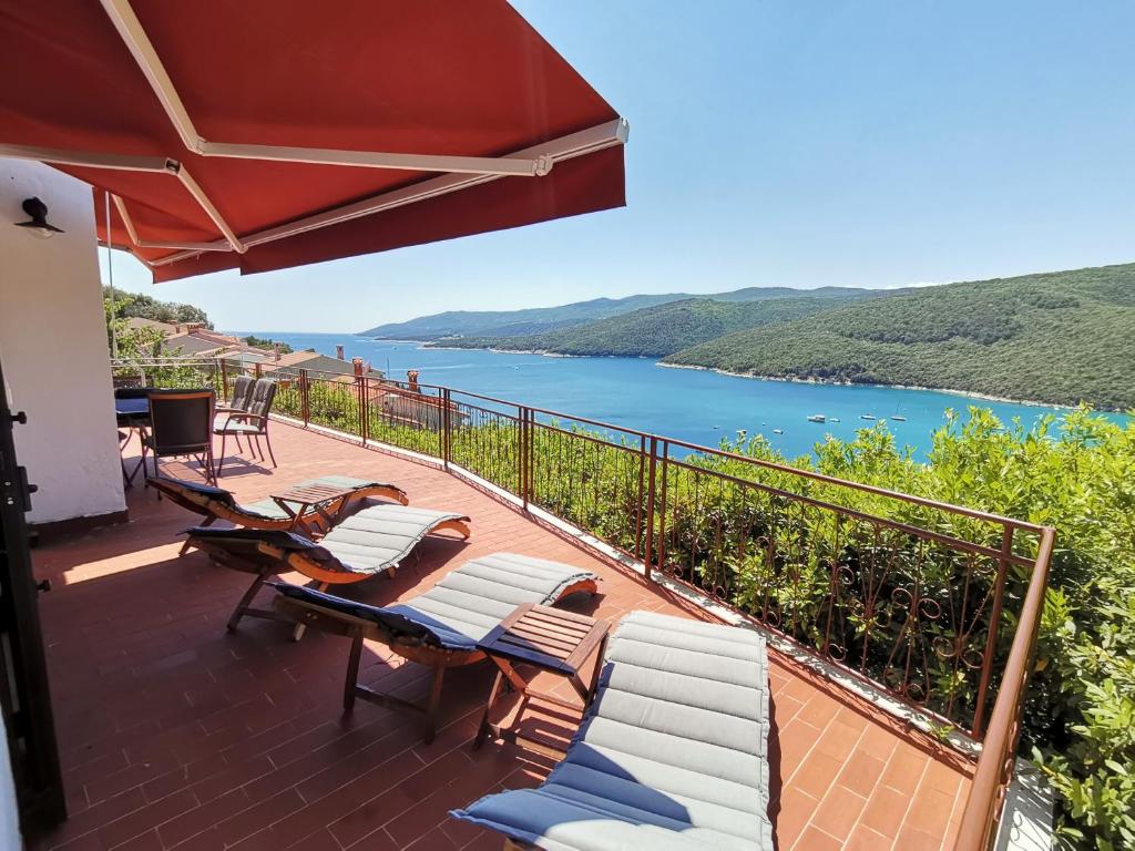 a balcony with chairs and a view of the water at ISTRIEN-ADRIA in Rabac