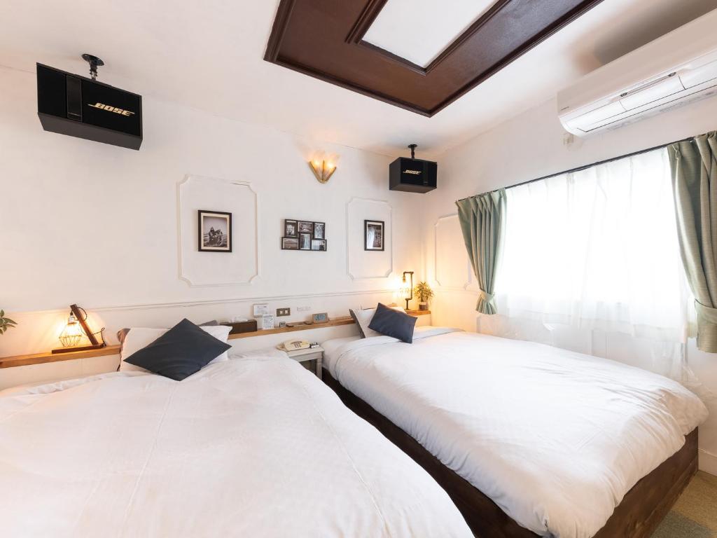 Postel nebo postele na pokoji v ubytování Tabist Hotel Nizi Fuefuki Misaka