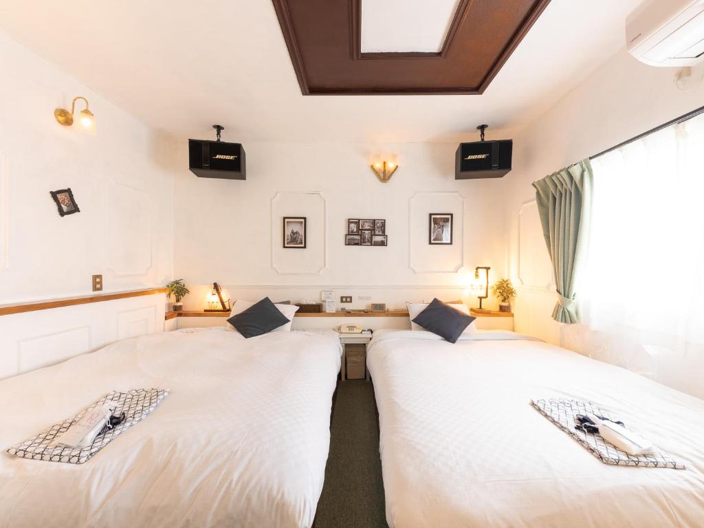 Postel nebo postele na pokoji v ubytování Tabist Hotel Nizi Fuefuki Misaka