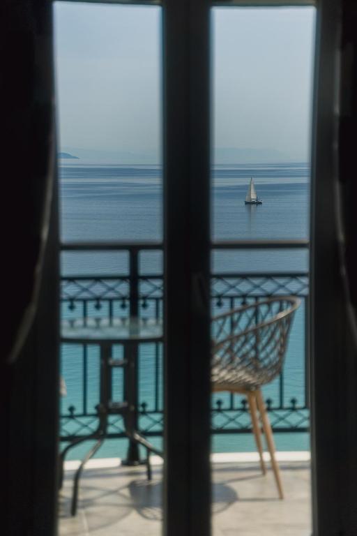 a view of the ocean from a window at Stellatos House in Poros