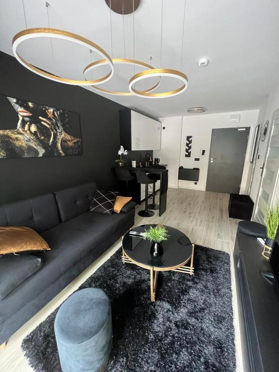 a living room with a couch and a table at Black Amber in Władysławowo