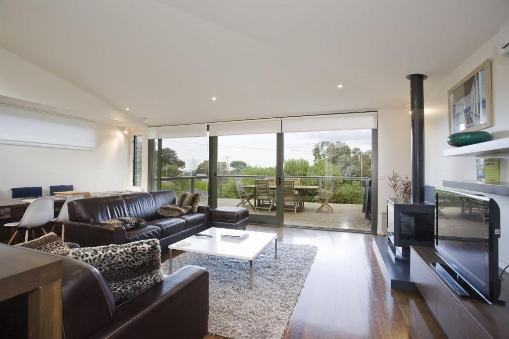 a living room with a couch and a table at Beachside At Breakers in Lorne