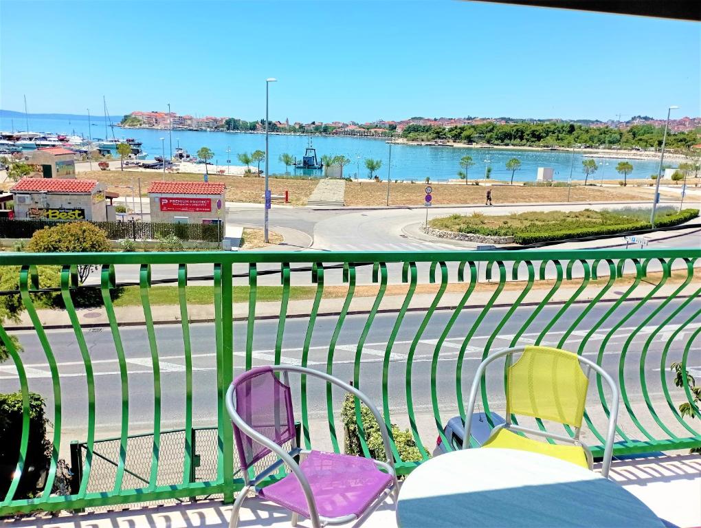 a balcony with chairs and a view of the water at Penthouse apartment with a Great View in Podstrana