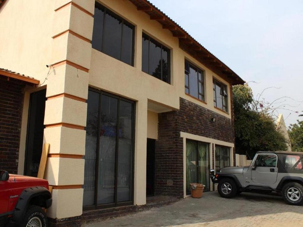 a truck parked in front of a building at Garden Cottage in Alberton