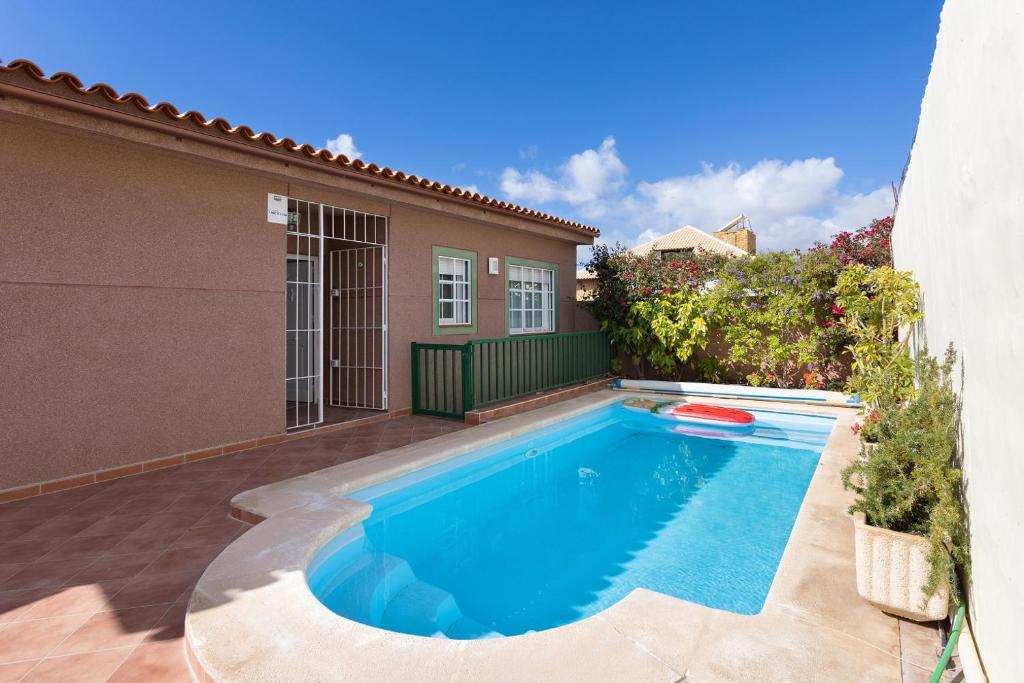 a swimming pool in the backyard of a house at Casa Melocoton - Private pool - Ocean View - BBQ - Garden - Terrace - Free Wifi - Child & Pet-Friendly - 4 bedrooms - 8 people in La Listada
