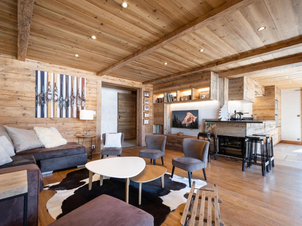 a living room with a couch and a table and a piano at Appartement La Clusaz, 4 pièces, 7 personnes - FR-1-304-232 in La Clusaz