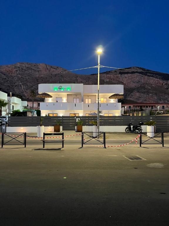 a parking lot in front of a building with a street light at AR Palace Hotel - Palermo in Isola delle Femmine
