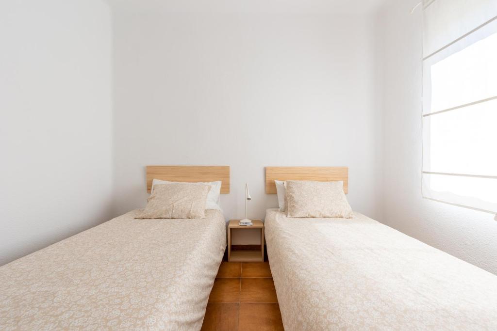 Posteľ alebo postele v izbe v ubytovaní Apartamento Residencial Limonar