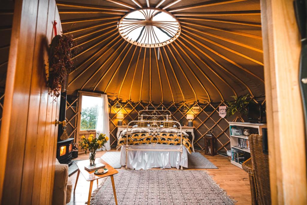 a room with a bed in a yurt at Sunbank Yurt in Llangollen
