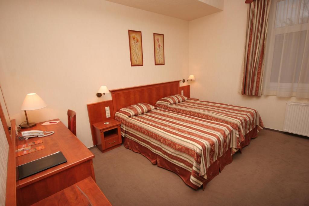 Postel nebo postele na pokoji v ubytování Hotel Central
