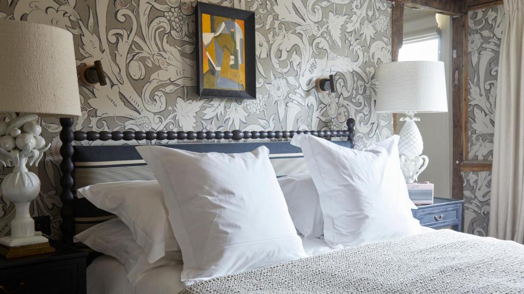 a bedroom with a bed with white pillows at The George In Rye in Rye