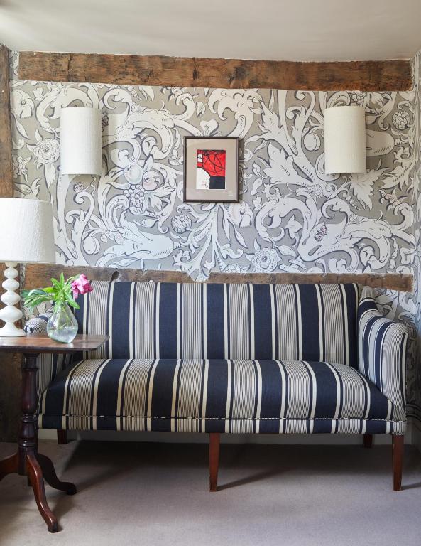 a bench in a living room with a wallpaper at The George In Rye in Rye