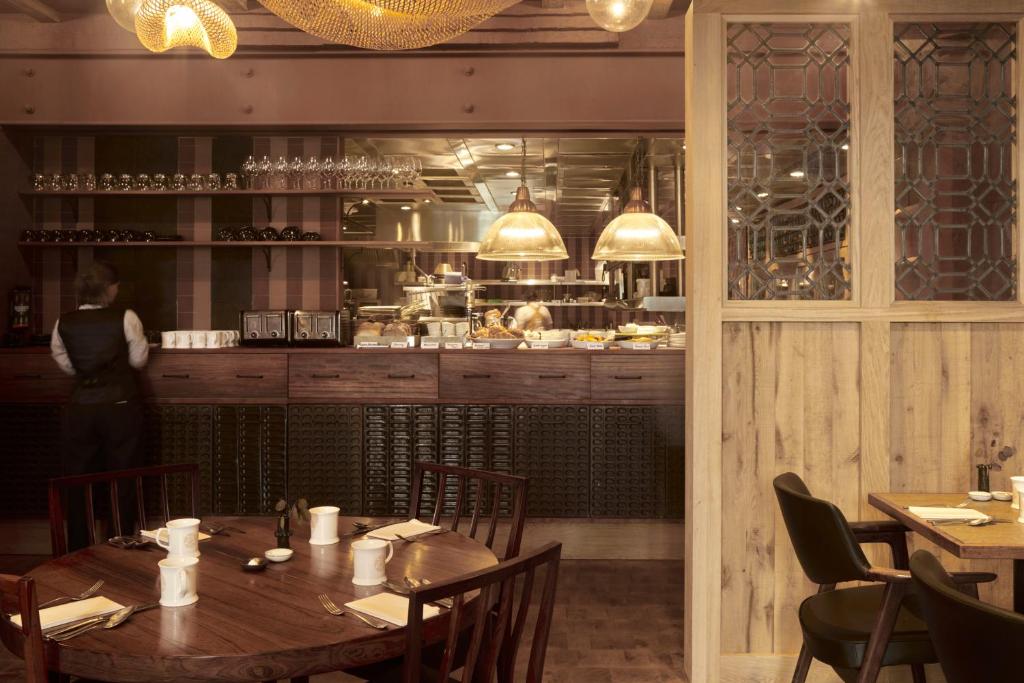 a dining room with a table and a kitchen at The George In Rye in Rye