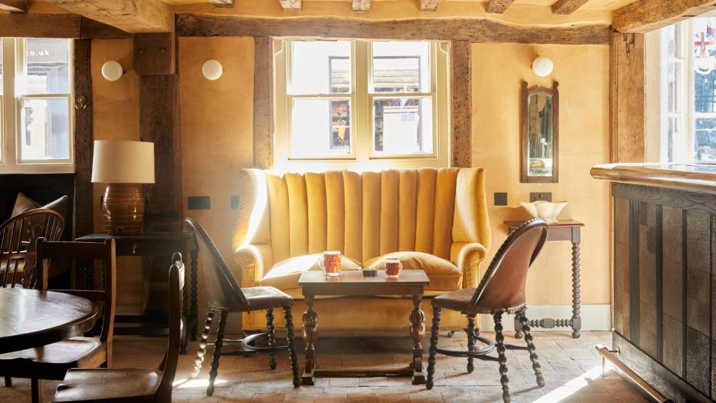 a restaurant with chairs and a table in a room at The George In Rye in Rye