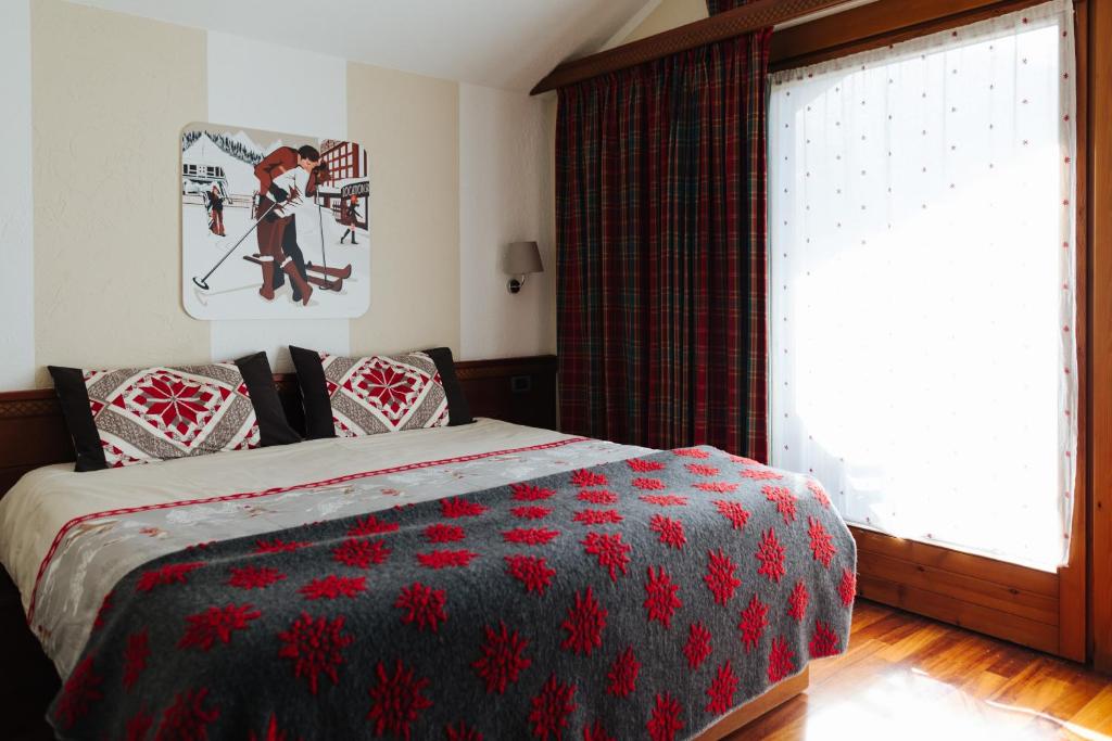 Postel nebo postele na pokoji v ubytování Hotel Walser Courmayeur