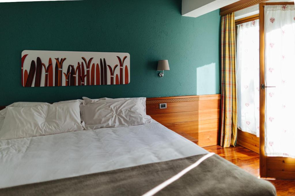 Postel nebo postele na pokoji v ubytování Hotel Walser Courmayeur