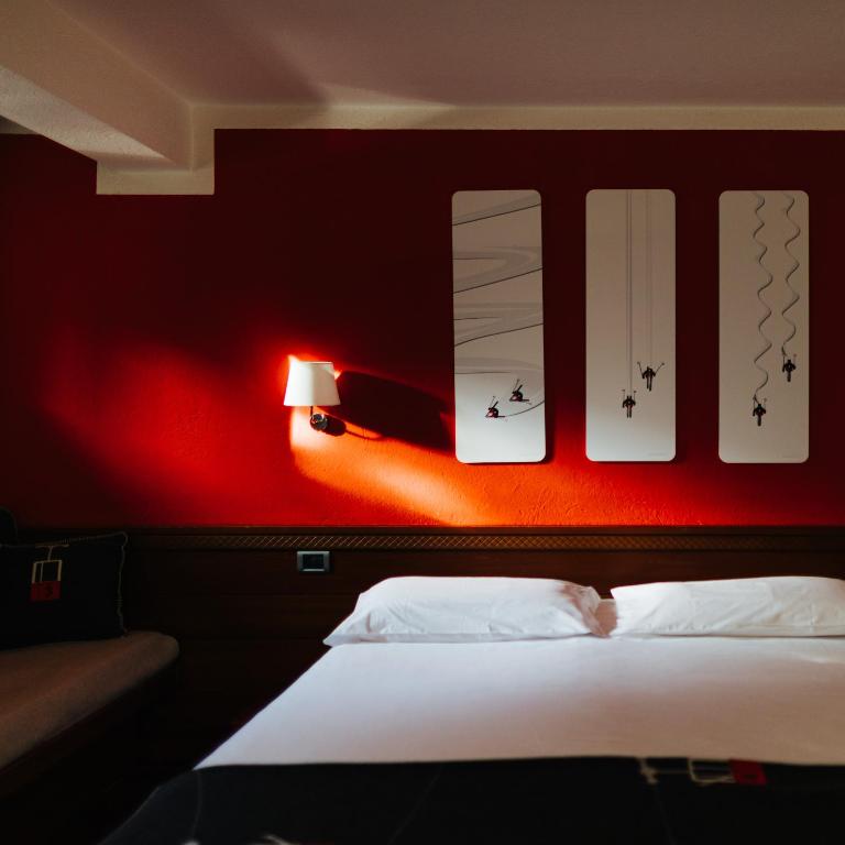 Postel nebo postele na pokoji v ubytování Hotel Walser Courmayeur