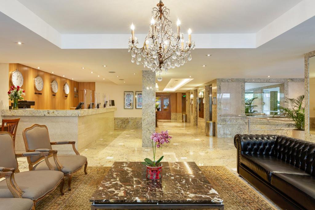 a living room with a chandelier and a lobby at Windsor Copa Hotel in Rio de Janeiro