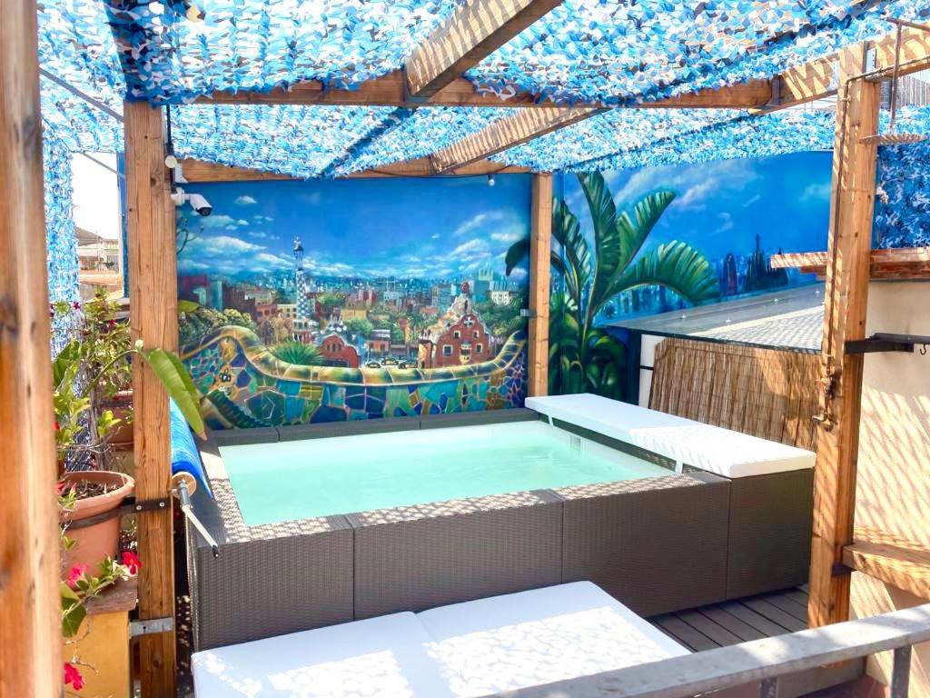 a swimming pool on a balcony with a mural at Àmfores Boutique Guest House in Barcelona