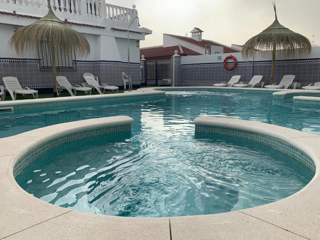 a swimming pool in the middle of a building at Apartamentos Costa Luz in Matalascañas