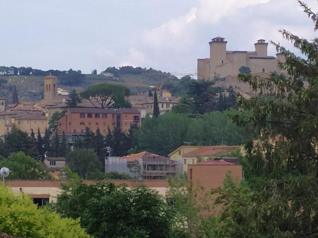 a view of a city with a castle on a hill at Una Casetta InterVineas in Spoleto