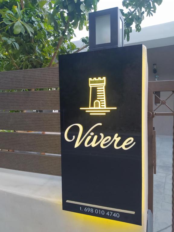 a sign for a vrere sign on a sidewalk at Vivere studios in Parga