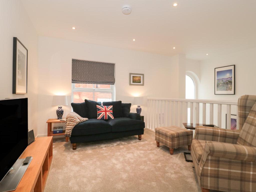 a living room with a couch and a chair at Flat 2 in Bournemouth