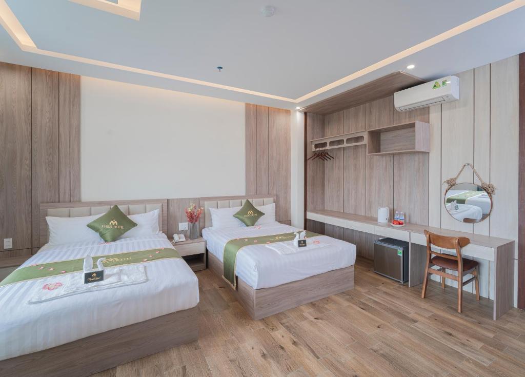 Postel nebo postele na pokoji v ubytování Maris Da Nang Hotel & Apartment