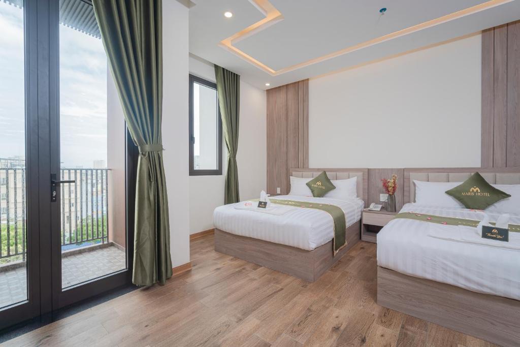 Postel nebo postele na pokoji v ubytování Maris Da Nang Hotel & Apartment