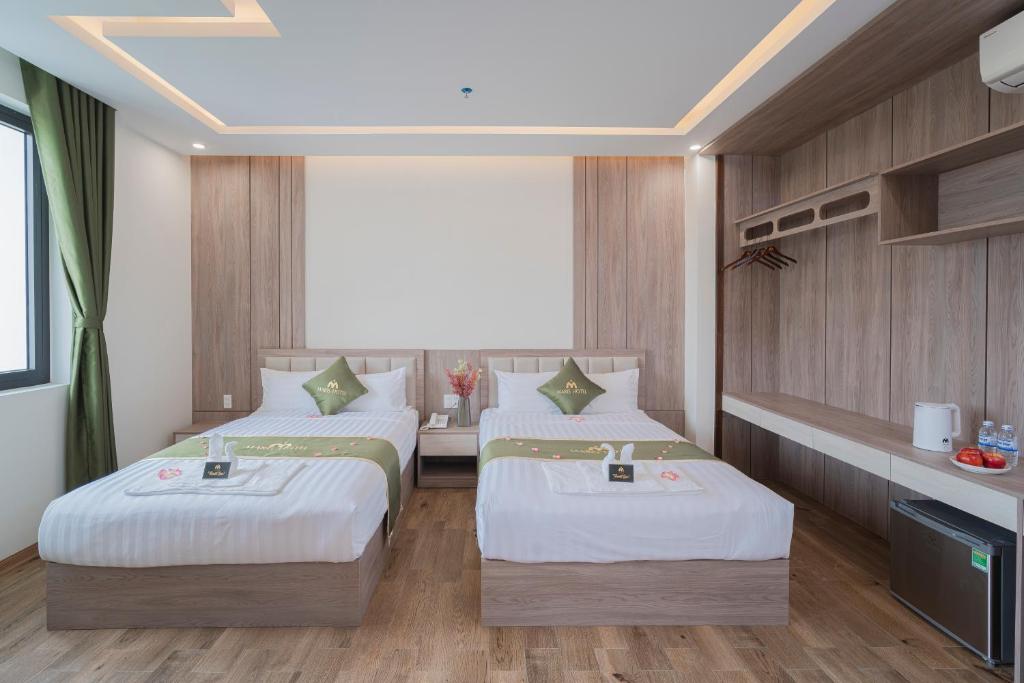 Postel nebo postele na pokoji v ubytování Maris Da Nang Hotel & Apartment