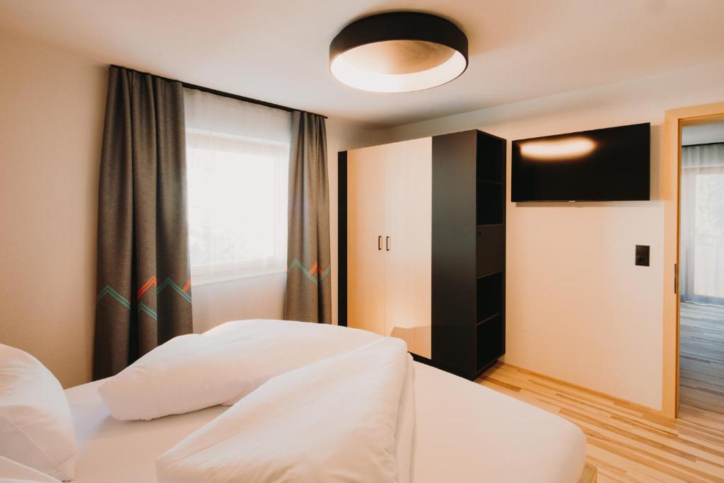 Posteľ alebo postele v izbe v ubytovaní Alpin - Studios & Suites