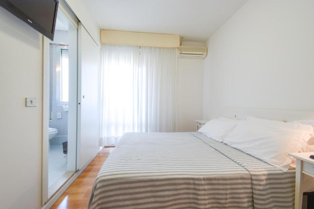 Postel nebo postele na pokoji v ubytování Hotel Janeiro