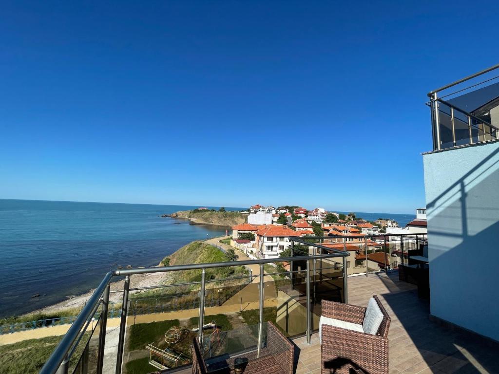 a view of the ocean from the balcony of a house at Апартаменти Генезис Ахтопол in Ahtopol