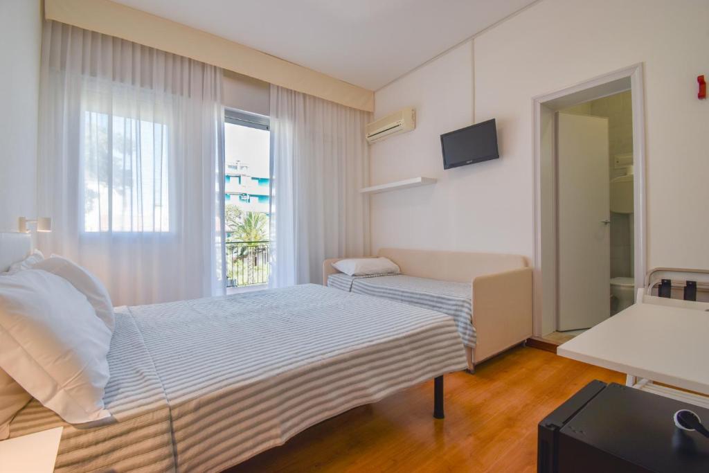 Postel nebo postele na pokoji v ubytování Hotel Janeiro