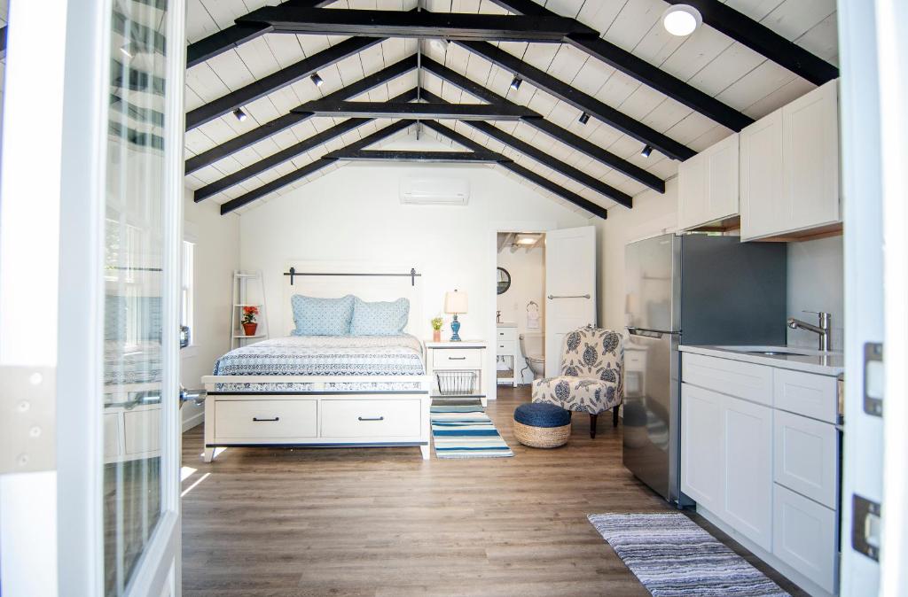 a bedroom with a bed and a kitchen at Prince of Whales in Truro
