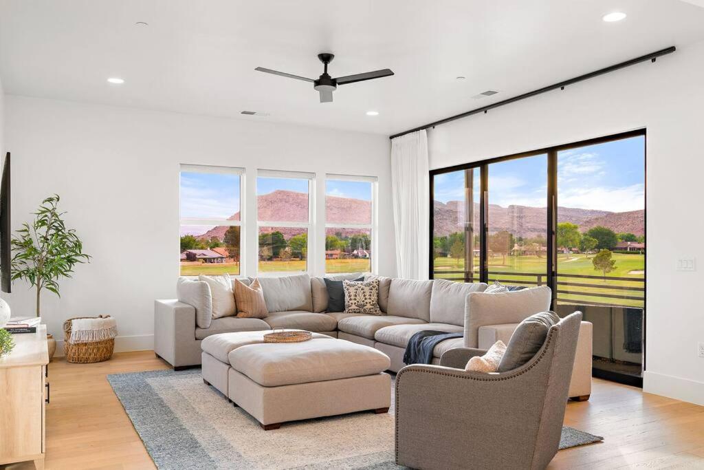 a living room with a couch and chairs and windows at Villa 22 a Fairway to Heaven, brand new listing! Stunning Views! in St. George