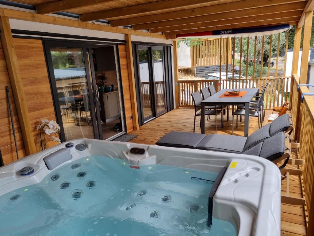 a hot tub on a deck with a table at Memita Mobile homes, Selce in Selce